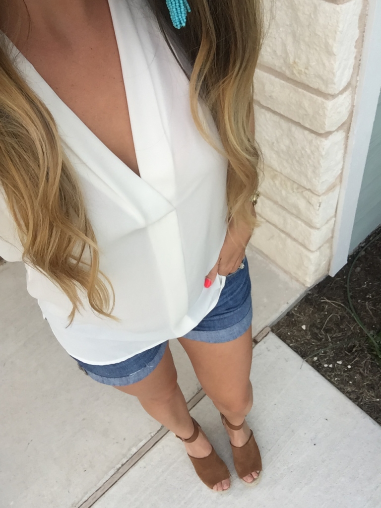 White blouse and cuffed jean shorts