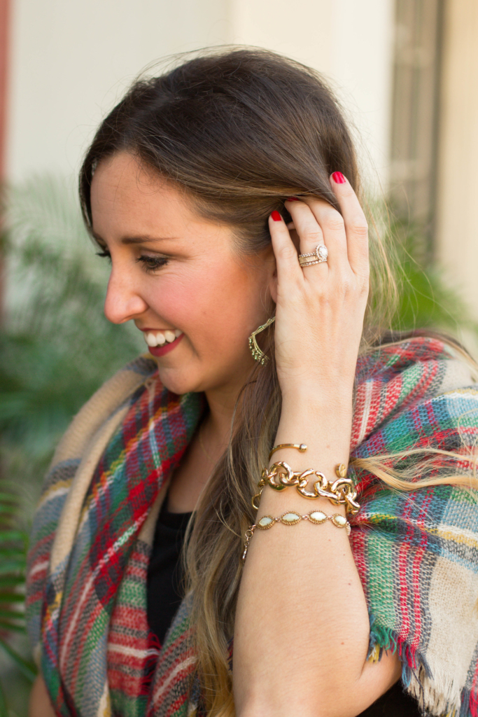 Stacked gold bracelets with classic plaid scarf