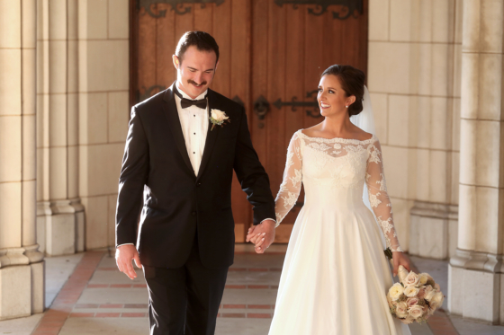 bride and groom after ceremony, old wooden door, vintage bridal gown, black tuxedo