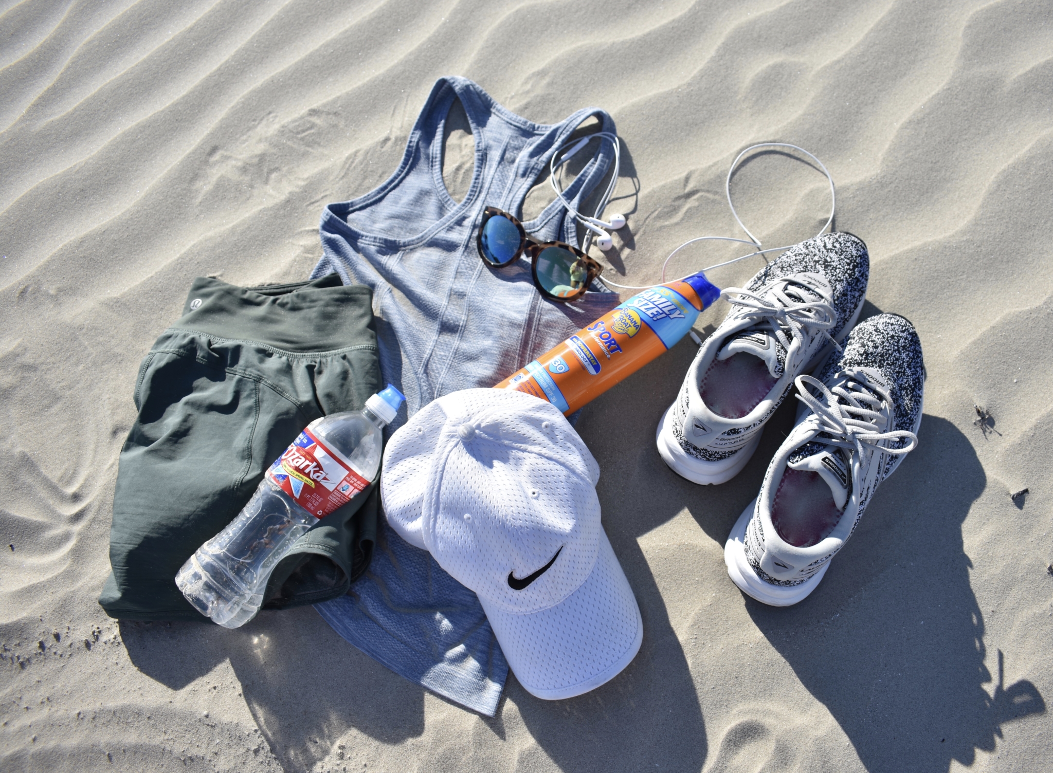 lulu lemon tank and shorts, brooks running shoes, nike hat, sunscreen, bottled water and sunglasses